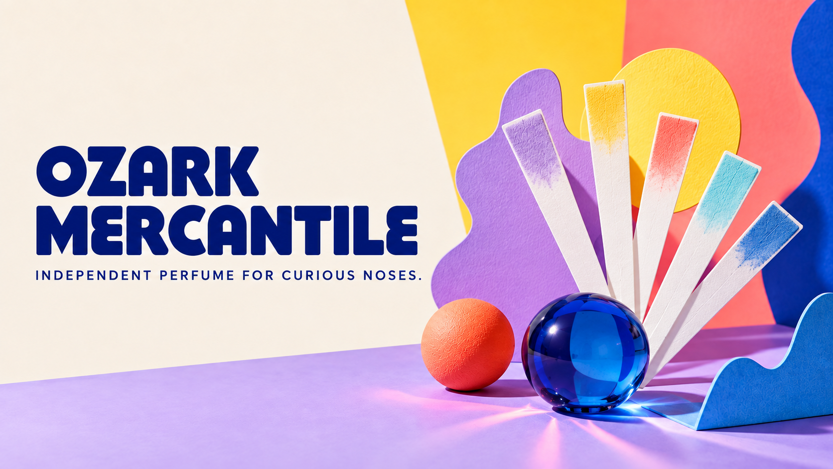 Ozark Mercantile logo beside colorful scent blotters and abstract studio shapes
